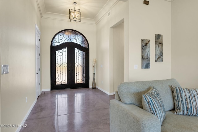 976 W Las Lomitas Rd, Tucson, AZ 85704 - entryway featuring french doors, a chandelier, finished concrete flooring, and ornamental molding