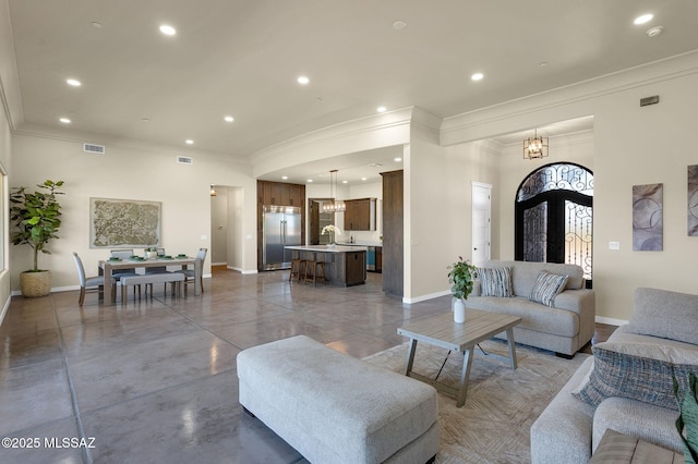 976 W Las Lomitas Rd, Tucson, AZ 85704 - living room featuring ornamental molding, recessed lighting, a chandelier, and concrete floors