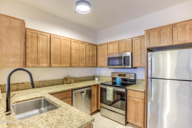 1500 E Pusch Wilderness Dr Unit 10106, Tucson, AZ 85737 - kitchen with appliances with stainless steel finishes, a sink, light stone countertops, and light tile patterned floors