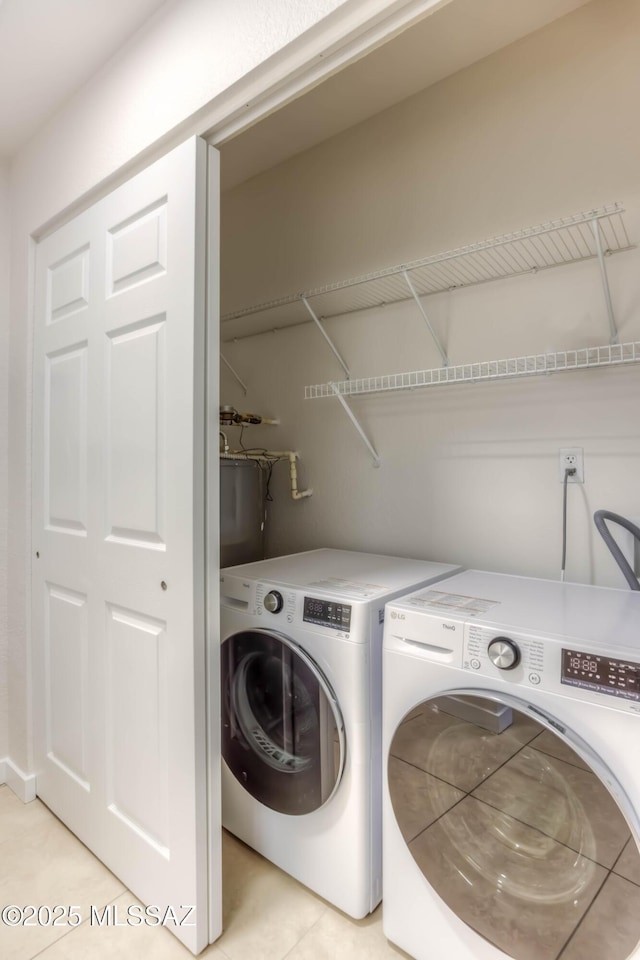 1500 E Pusch Wilderness Dr Unit 10106, Tucson, AZ 85737 - laundry room with washing machine and clothes dryer and light tile patterned flooring