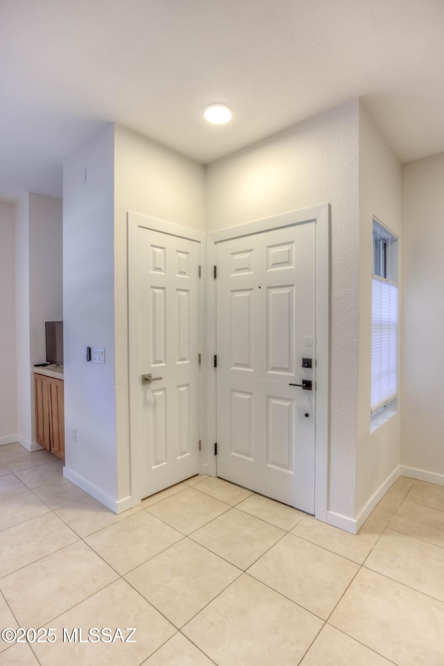 1500 E Pusch Wilderness Dr Unit 10106, Tucson, AZ 85737 - entryway featuring light tile patterned floors and baseboards