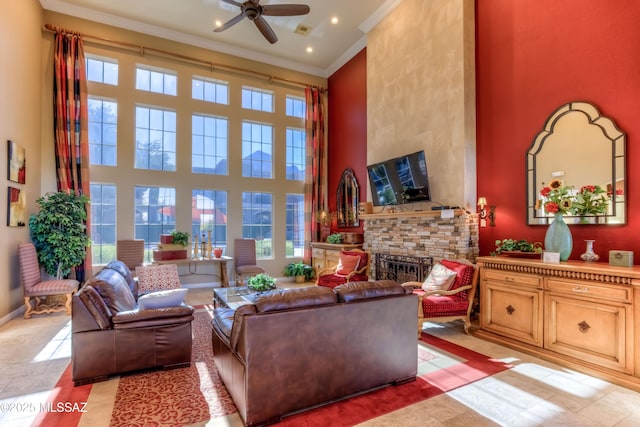 1500 E Pusch Wilderness Dr Unit 10106, Tucson, AZ 85737 - living area with a high ceiling, ornamental molding, a fireplace, a ceiling fan, and baseboards