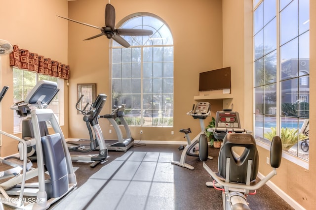 1500 E Pusch Wilderness Dr Unit 10106, Tucson, AZ 85737 - exercise area featuring baseboards, ceiling fan, and a towering ceiling