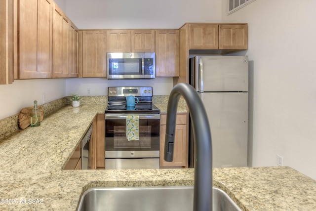 1500 E Pusch Wilderness Dr Unit 10106, Tucson, AZ 85737 - kitchen featuring stainless steel appliances, a sink, and light stone counters