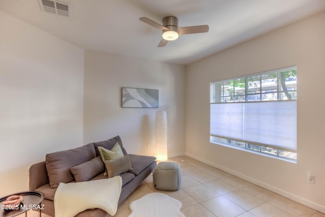 1500 E Pusch Wilderness Dr Unit 10106, Tucson, AZ 85737 - living room with ceiling fan, light tile patterned floors, and baseboards