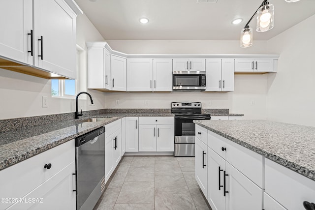 1844 Burns Ct, Rio Rico, AZ 85648 - kitchen featuring stainless steel appliances, a sink, white cabinets, light stone counters, and recessed lighting