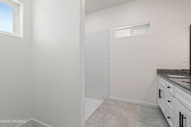 1844 Burns Ct, Rio Rico, AZ 85648 - bathroom with walk in shower, double vanity, plenty of natural light, and baseboards
