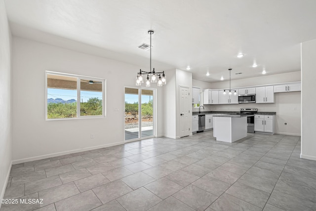 1844 Burns Ct, Rio Rico, AZ 85648 - kitchen with stainless steel appliances, open floor plan, dark countertops, baseboards, and a chandelier