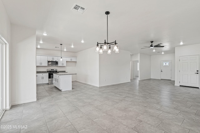 1844 Burns Ct, Rio Rico, AZ 85648 - kitchen featuring stainless steel appliances, open floor plan, a ceiling fan, white cabinetry, and baseboards