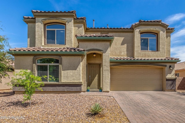 8751 W Saguaro Moon Rd, Marana, AZ 85653 - mediterranean / spanish-style house with a tile roof, a garage, driveway, and stucco siding