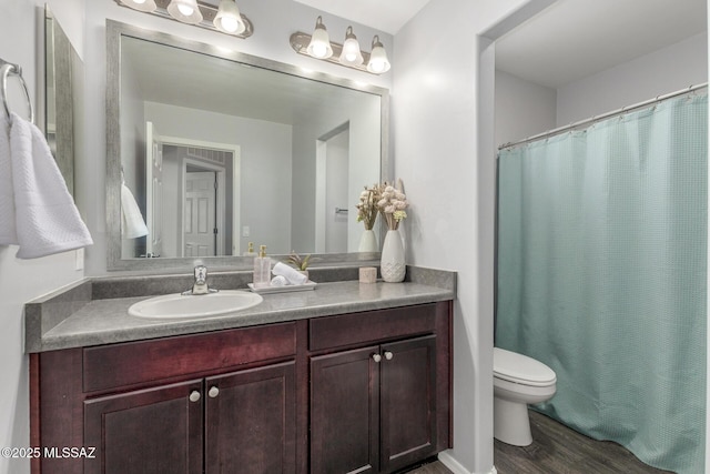 8751 W Saguaro Moon Rd, Marana, AZ 85653 - bathroom with toilet, vanity, wood finished floors, and curtained shower