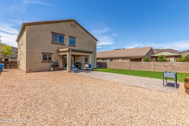 8751 W Saguaro Moon Rd, Marana, AZ 85653 - rear view of property featuring a patio area, a fenced backyard, and stucco siding