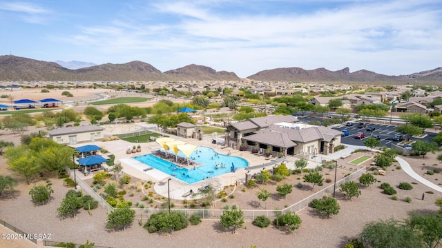 8751 W Saguaro Moon Rd, Marana, AZ 85653 - aerial perspective of suburban area with a pool area and a mountainous background