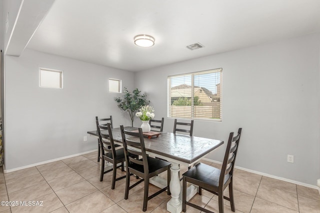 8751 W Saguaro Moon Rd, Marana, AZ 85653 - dining space featuring light tile patterned flooring and baseboards
