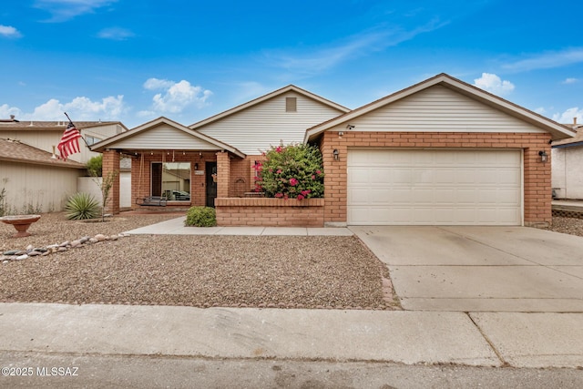 4522 W Vander Bie Pl, Tucson, AZ 85741 - view of front of house with brick siding, a garage, concrete driveway, and covered porch