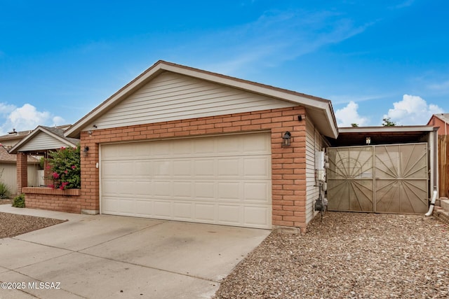 4522 W Vander Bie Pl, Tucson, AZ 85741 - view of front of property with brick siding, an attached garage, and concrete driveway