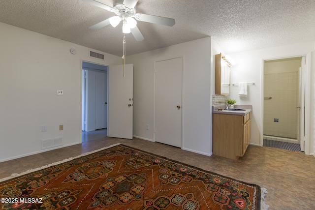 4557 E San Francisco Blvd, Tucson, AZ 85712 - bedroom with a textured ceiling, ensuite bath, and a ceiling fan