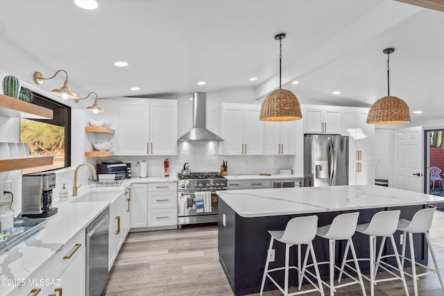 835 E Camino De Fray Marcos, Tucson, AZ 85718 - kitchen with wall chimney exhaust hood, stainless steel appliances, open shelves, a center island, and decorative backsplash