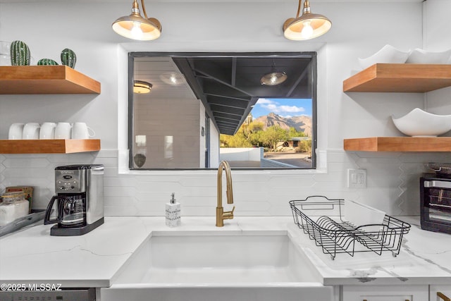 835 E Camino De Fray Marcos, Tucson, AZ 85718 - kitchen view of open shelves, a sink, and backsplash