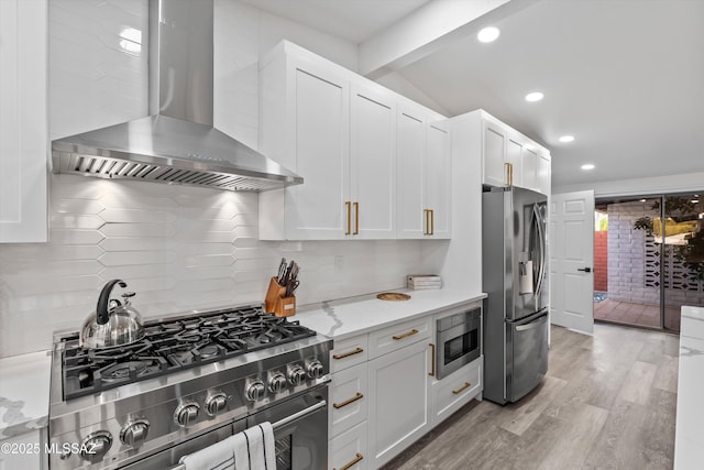 835 E Camino De Fray Marcos, Tucson, AZ 85718 - kitchen featuring stainless steel appliances, wall chimney exhaust hood, white cabinetry, backsplash, and recessed lighting