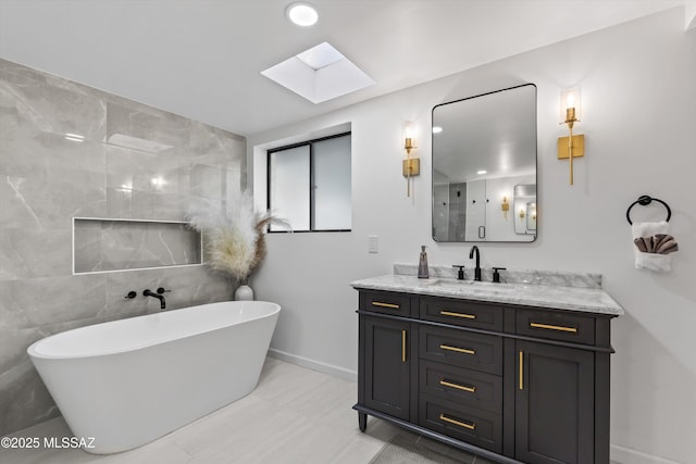 835 E Camino De Fray Marcos, Tucson, AZ 85718 - bathroom with a skylight, vanity, a freestanding bath, and baseboards
