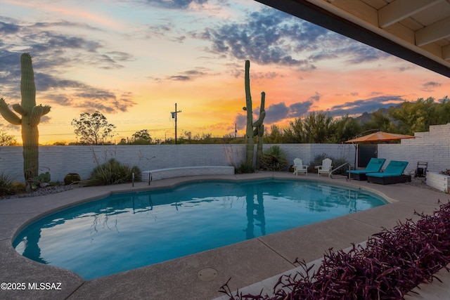 835 E Camino De Fray Marcos, Tucson, AZ 85718 - pool at dusk featuring a fenced backyard and a patio area