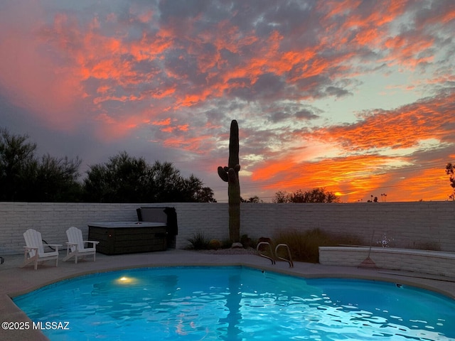 835 E Camino De Fray Marcos, Tucson, AZ 85718 - pool at dusk featuring a fenced backyard and a patio area