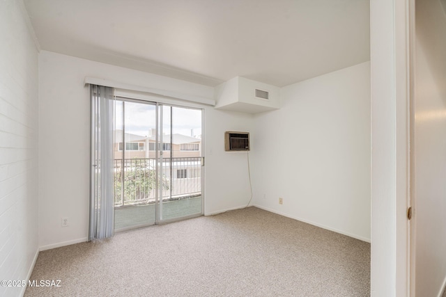 1470 S Palo Verde Ave Unit J 201, Tucson, AZ 85713 - unfurnished room featuring carpet, an AC wall unit, and baseboards
