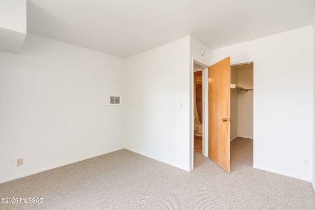 1470 S Palo Verde Ave Unit J 201, Tucson, AZ 85713 - unfurnished bedroom with carpet, a spacious closet, and baseboards
