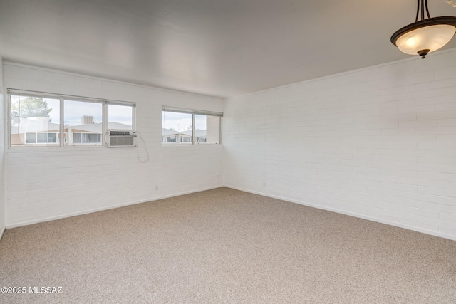 1470 S Palo Verde Ave Unit J 201, Tucson, AZ 85713 - carpeted empty room featuring brick wall, cooling unit, and baseboards