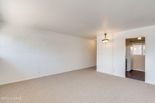 1470 S Palo Verde Ave Unit J 201, Tucson, AZ 85713 - empty room featuring carpet flooring, brick wall, and baseboards