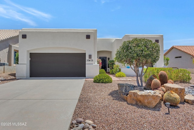 37671 S Hill Side Dr, Tucson, AZ 85739 - southwest-style home with stucco siding, concrete driveway, and an attached garage