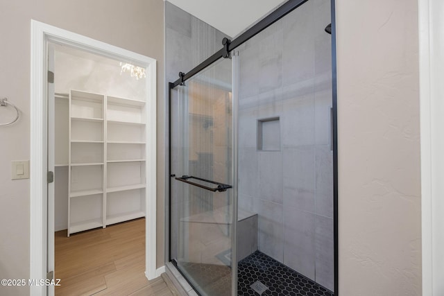 37671 S Hill Side Dr, Tucson, AZ 85739 - bathroom featuring a shower stall, a spacious closet, and wood finished floors