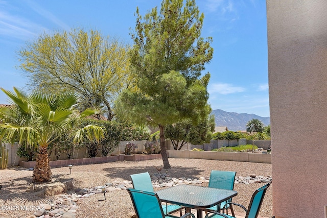 37671 S Hill Side Dr, Tucson, AZ 85739 - fenced backyard featuring a mountain view, a patio, and outdoor dining space