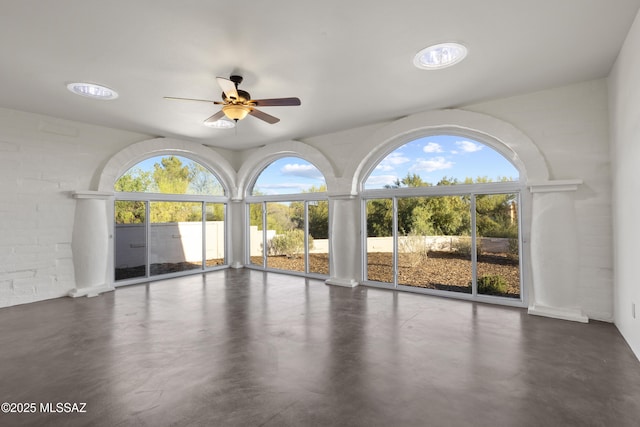 6355 N Camino De Santa Valera, Tucson, AZ 85718 - empty room featuring plenty of natural light, a ceiling fan, and finished concrete floors