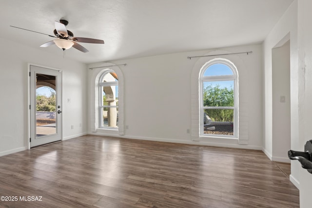 6355 N Camino De Santa Valera, Tucson, AZ 85718 - unfurnished living room with wood finished floors, ceiling fan, and baseboards