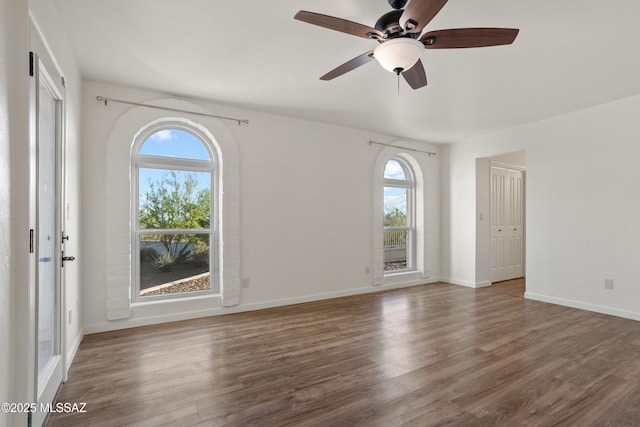 6355 N Camino De Santa Valera, Tucson, AZ 85718 - empty room with healthy amount of natural light, wood finished floors, a ceiling fan, and baseboards