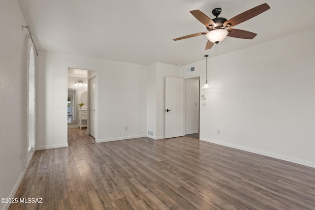 6355 N Camino De Santa Valera, Tucson, AZ 85718 - unfurnished room featuring a ceiling fan, wood finished floors, and baseboards