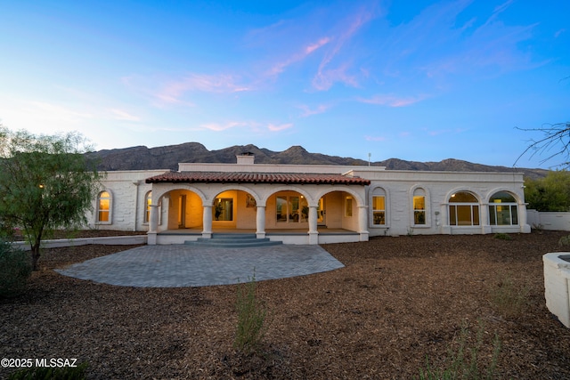6355 N Camino De Santa Valera, Tucson, AZ 85718 - back of house with covered porch, a chimney, and a mountain view