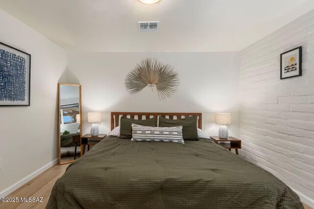 5601 E Baker St, Tucson, AZ 85711 - bedroom featuring wood finished floors and baseboards