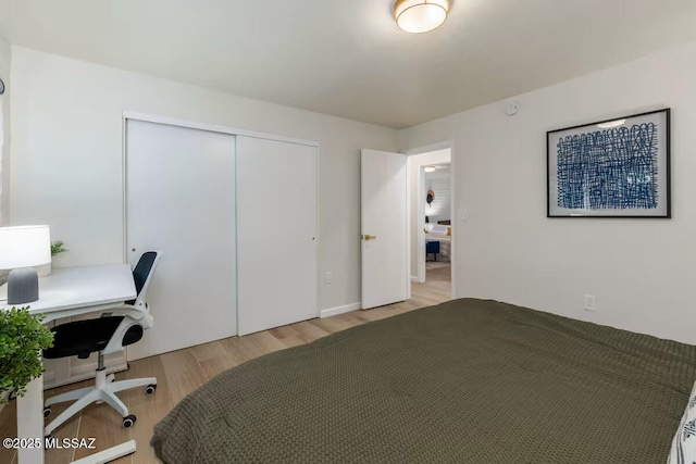5601 E Baker St, Tucson, AZ 85711 - bedroom featuring a closet, light wood-style flooring, and a desk