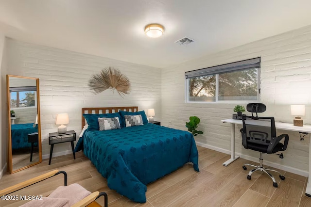 5601 E Baker St, Tucson, AZ 85711 - bedroom featuring wood finished floors, baseboards, and an office area