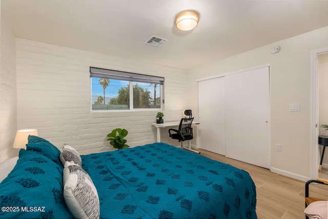 5601 E Baker St, Tucson, AZ 85711 - bedroom featuring light wood-style flooring, a closet, and baseboards