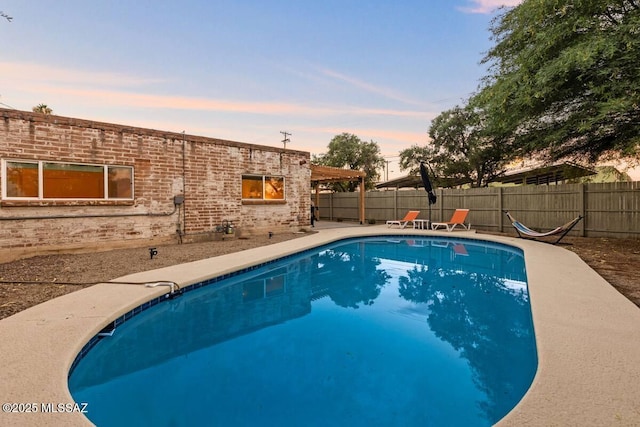 5601 E Baker St, Tucson, AZ 85711 - pool at dusk featuring a fenced backyard and a patio