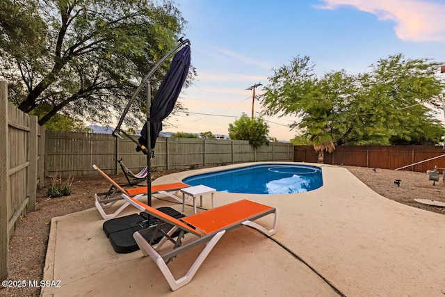 5601 E Baker St, Tucson, AZ 85711 - pool at dusk featuring a patio area and a fenced backyard