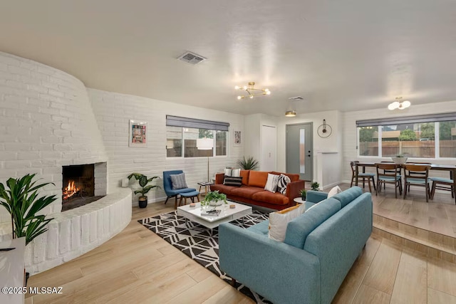 5601 E Baker St, Tucson, AZ 85711 - living area featuring wood finished floors and a brick fireplace