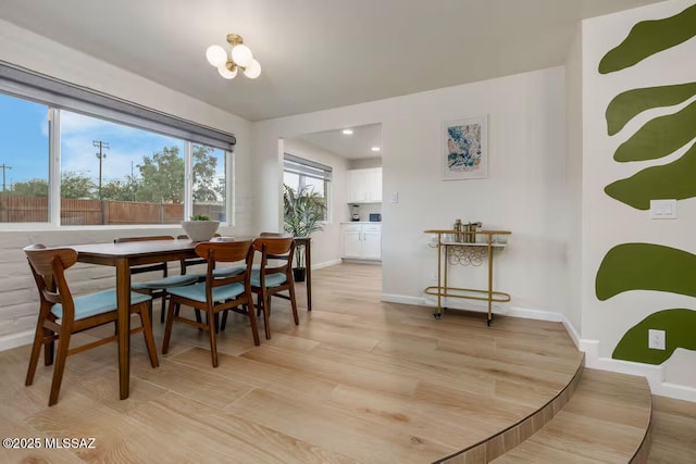 5601 E Baker St, Tucson, AZ 85711 - dining area with baseboards and light wood-type flooring