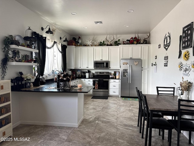 351 Calle Alta Vista Blvd, Clifton, AZ 85533 - kitchen featuring stainless steel appliances, dark countertops, a peninsula, white cabinets, and recessed lighting