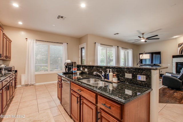 5457 S Canyon Oak Dr, Tucson, AZ 85747 - kitchen with an island with sink, a sink, open floor plan, dishwasher, and light tile patterned flooring