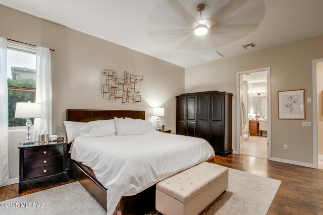 5457 S Canyon Oak Dr, Tucson, AZ 85747 - bedroom with dark wood-type flooring, baseboards, ensuite bathroom, and ceiling fan